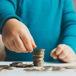 child counting and stacking coins, foreign child support