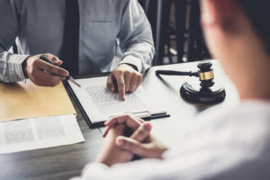 lawyer reviewing document with client, how to choose a business attorney in florida