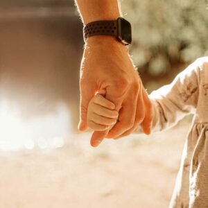 parent’s hand holding child’s hand, international child custody, foreign child support