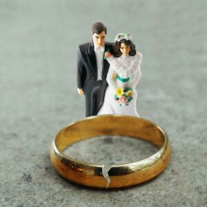 bride and groom cake topper with cracked wedding band, international divorce