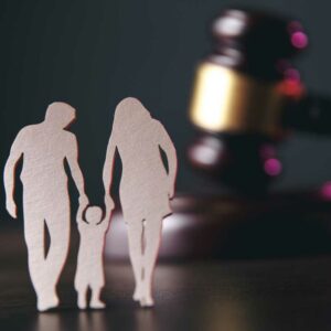 paper cut-out family in front of gavel, international family law, international child custody